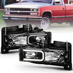 ANZO 1999-2000 Cadillac Escalade Crystal Headlights Light Bar Black Housing (Pair); 1999-2000